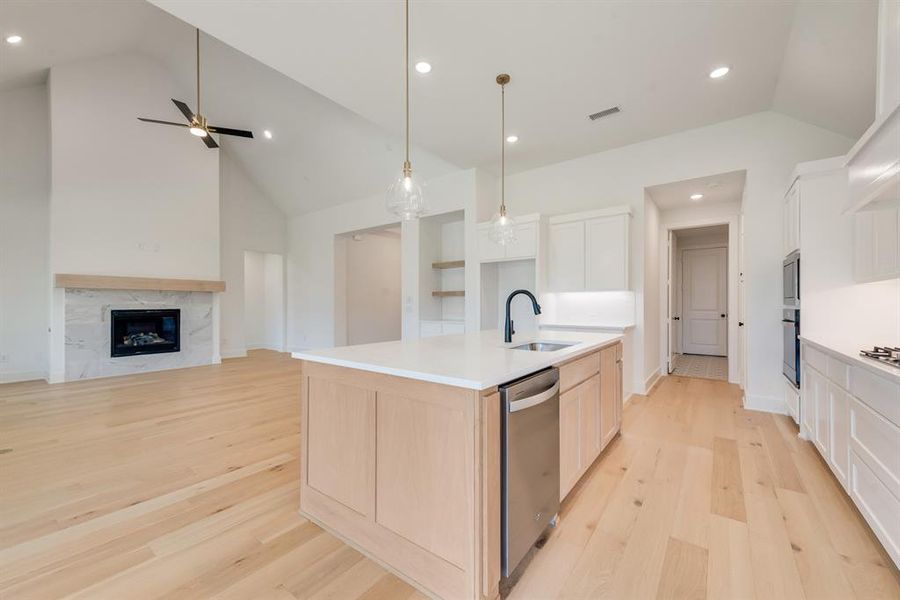 Kitchen featuring light wood-type flooring, open floor plan, recessed lighting, an island with sink, and dishwasher