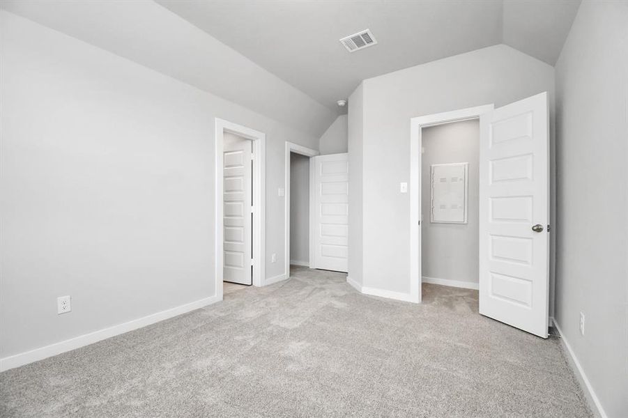 Secondary bedroom features plush carpeting, large windows that let in plenty of natural light, bright paint, and spacious closets. Sample photo of completed home with similar floor plan. Actual colors and selections may vary.