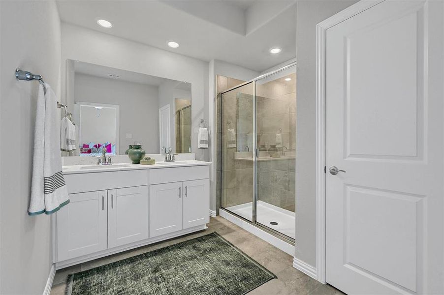 Bathroom featuring vanity and an enclosed shower