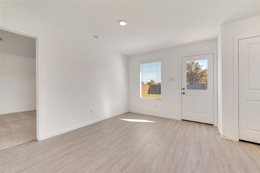 Foyer with light hardwood / wood-style flooring