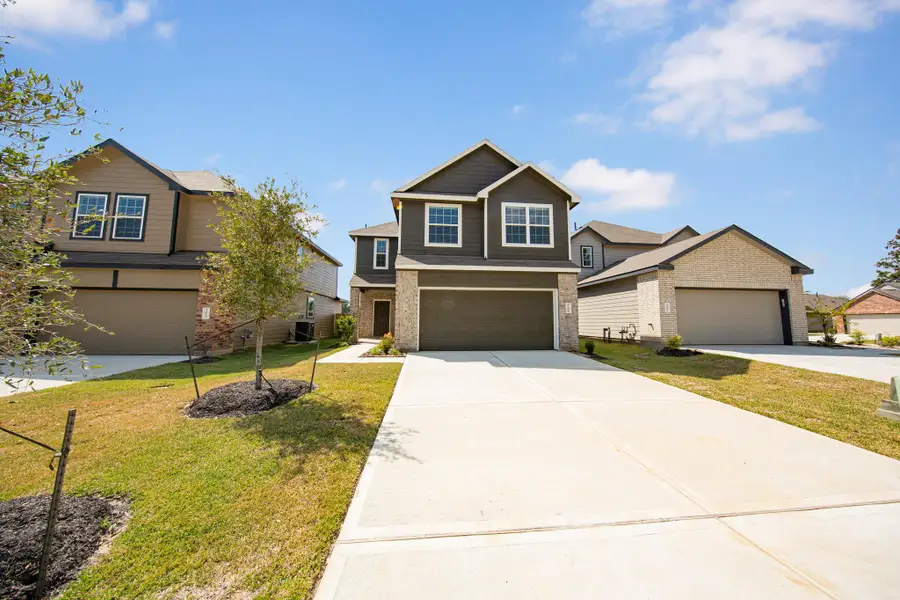 Front exterior of a new home in Mackenzie Creek, Conroe, TX, highlighting curb appeal (Image 14). Front exterior of a new home in Mackenzie Creek, Conroe, TX, highlighting curb appeal (Image 14).