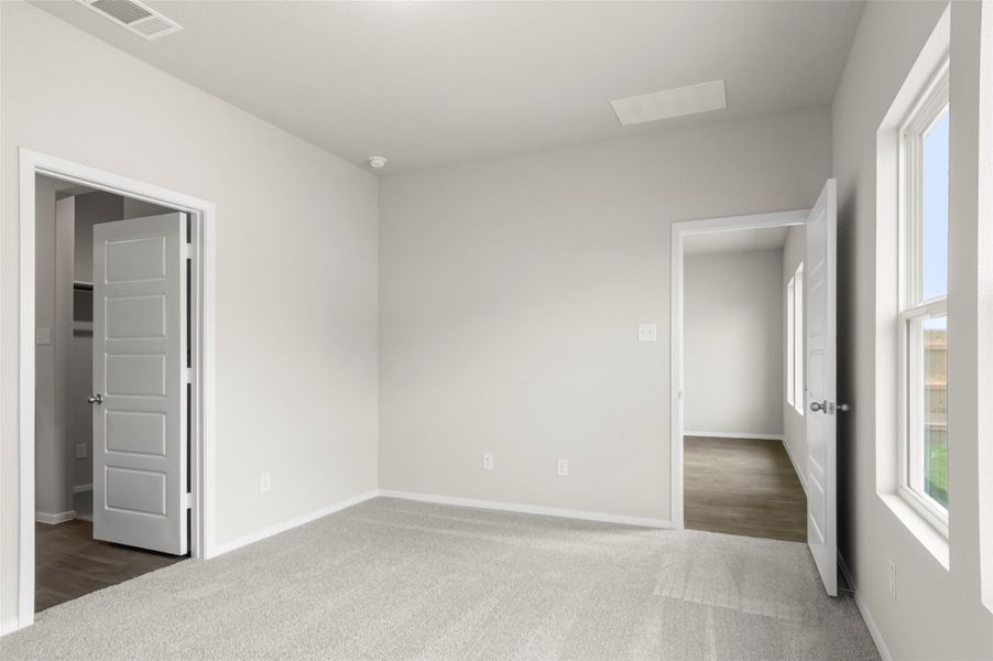 Empty room featuring carpet and baseboards Empty room featuring carpet and baseboards