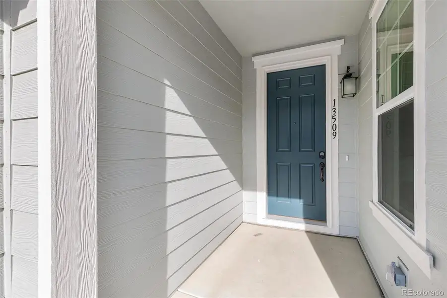 Exterior details and patio area of a home in Turnberry Villas, Commerce City (Image 3).