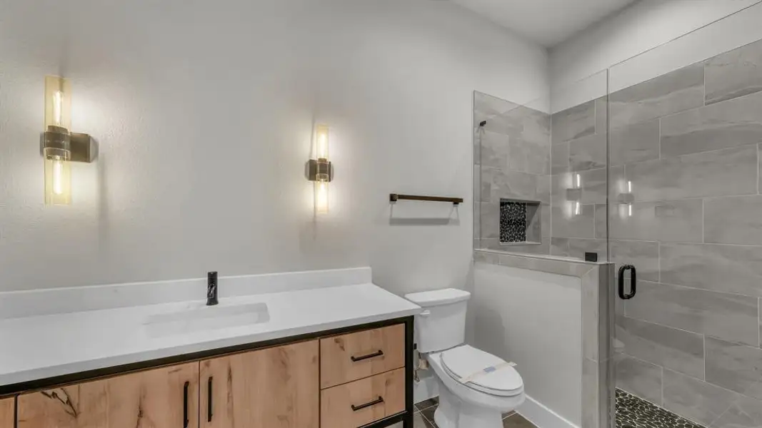 Bathroom vanity with light wood-finish cabinetry, a white countertop, and an undermount sink Bathroom vanity with light wood-finish cabinetry, a white countertop, and an undermount sink