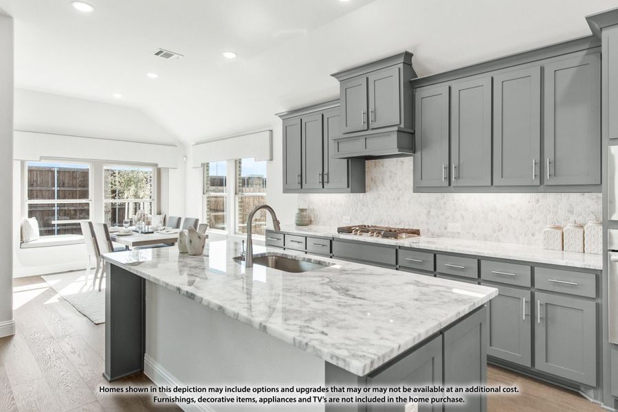 Kitchen with gray cabinets, marble island with sink, and tile backsplash open to dining area Kitchen with gray cabinets, marble island with sink, and tile backsplash open to dining area