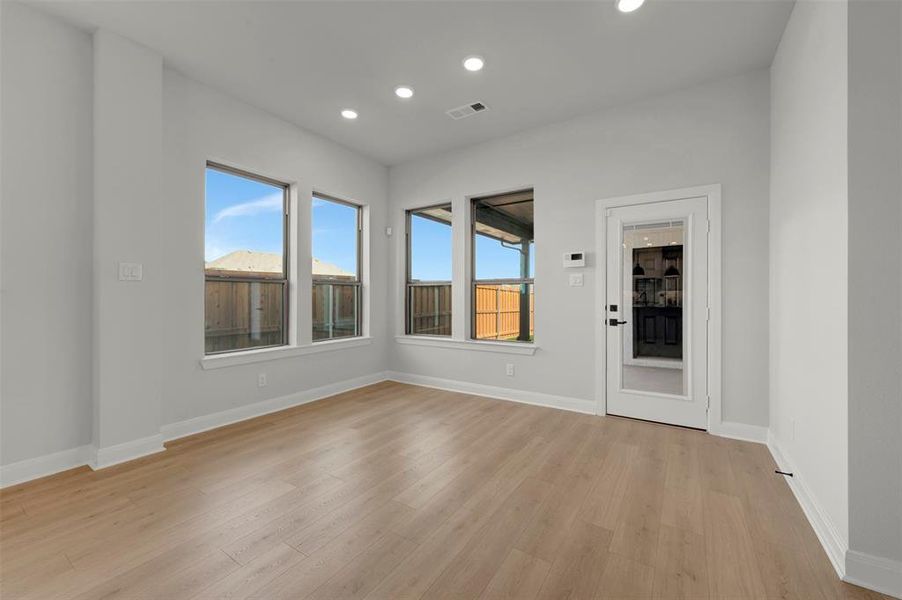 Unfurnished room featuring healthy amount of natural light, recessed lighting, and light wood finished floors