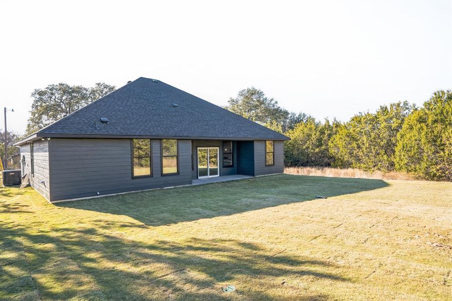 Back of house featuring a yard