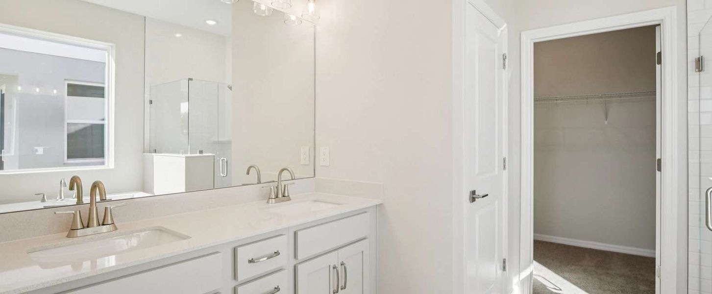 Primary bathroom features double sinks and a walk-in shower - Representative images and renderings are for illustrative purposes this home will feature our standard collection Primary bathroom features double sinks and a walk-in shower - Representative images and renderings are for illustrative purposes this home will feature our standard collection