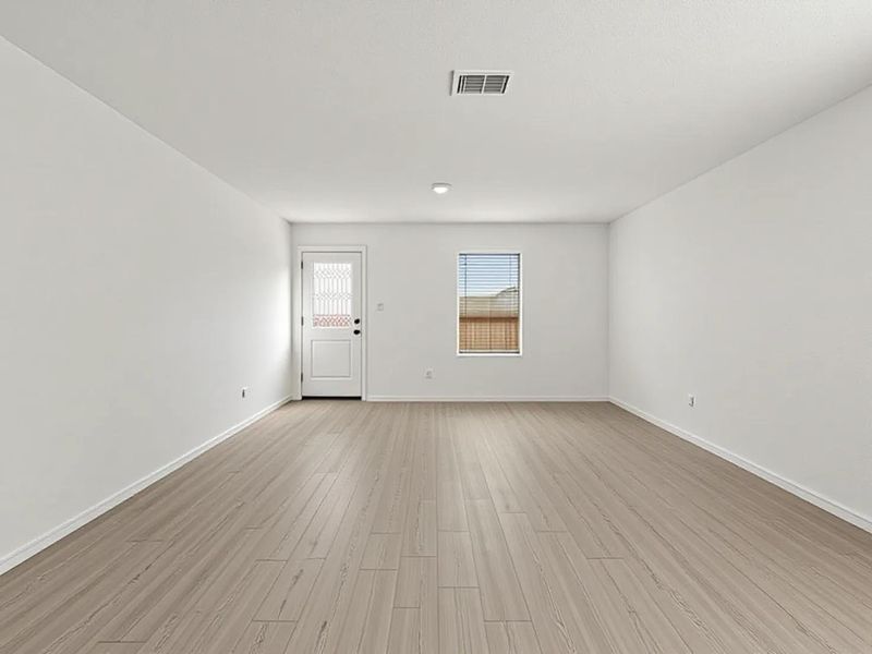 Photo has been enhanced with virtual modification.  Spare room featuring light wood-style floors and baseboards