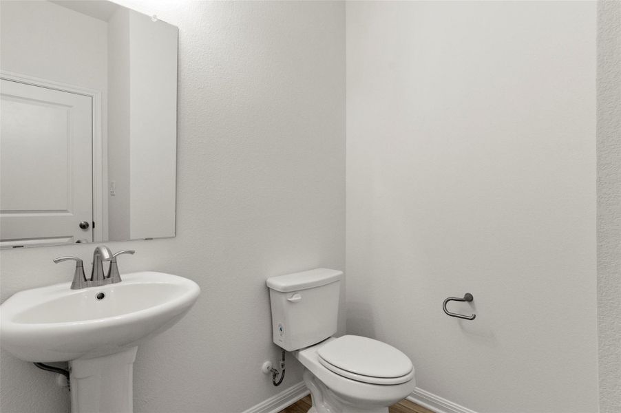 Bathroom with a textured wall and toilet Bathroom with a textured wall and toilet