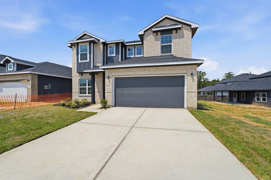 Front exterior of a new home in Magnolia Springs, Montgomery, TX, highlighting curb appeal (Image 2).