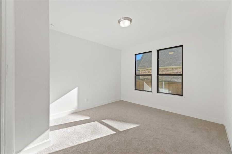 Carpeted empty room with baseboards