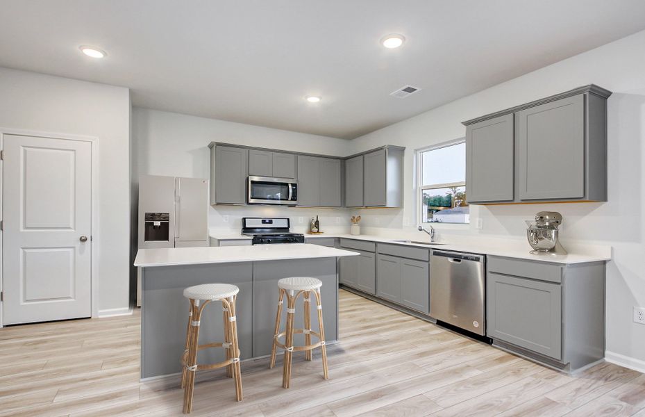 Rosella Kitchen features premium granite countertops and a kitchen island providing additional seating opportunities.