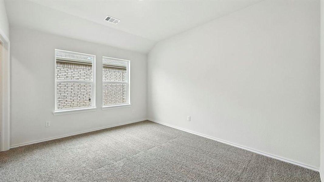 Room featuring light gray carpeting, crisp white walls, and a white baseboard trim Room featuring light gray carpeting, crisp white walls, and a white baseboard trim