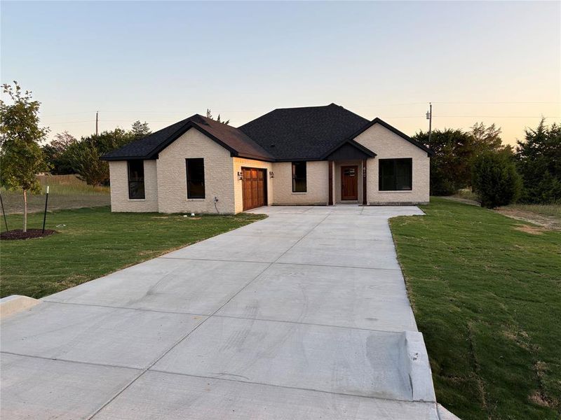 View of front of property featuring a lawn