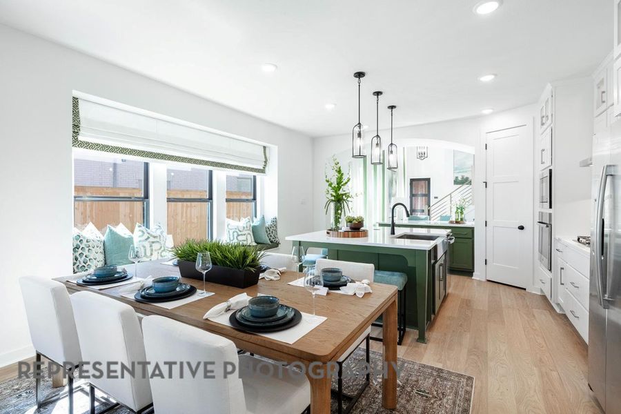 Dining room featuring light wood-style floors, recessed lighting, and arched walkways Dining room featuring light wood-style floors, recessed lighting, and arched walkways