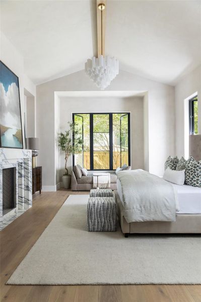 Features a vaulted ceiling, large picture windows, and a marble fireplace that adds warmth and ambiance. Features a vaulted ceiling, large picture windows, and a marble fireplace that adds warmth and ambiance.