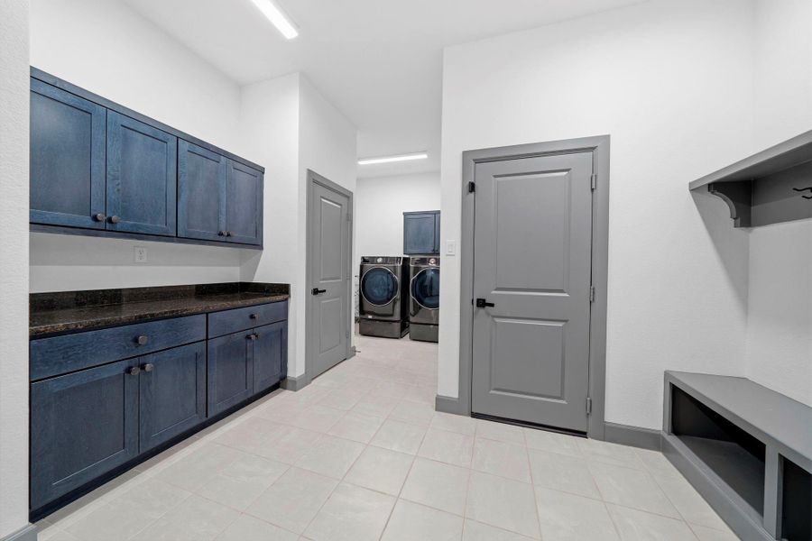 Spacious utility room with built-in cabinetry, extended counter space, and dedicated laundry area—designed for both functionality and everyday convenience.