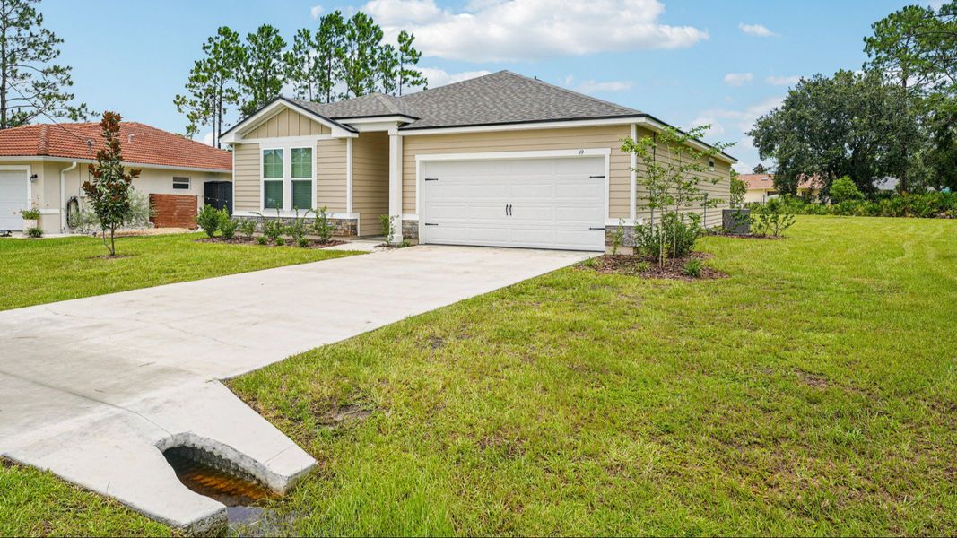 Front exterior of a new home in Palm Coast, Palm Coast, FL, highlighting curb appeal (Image 2).