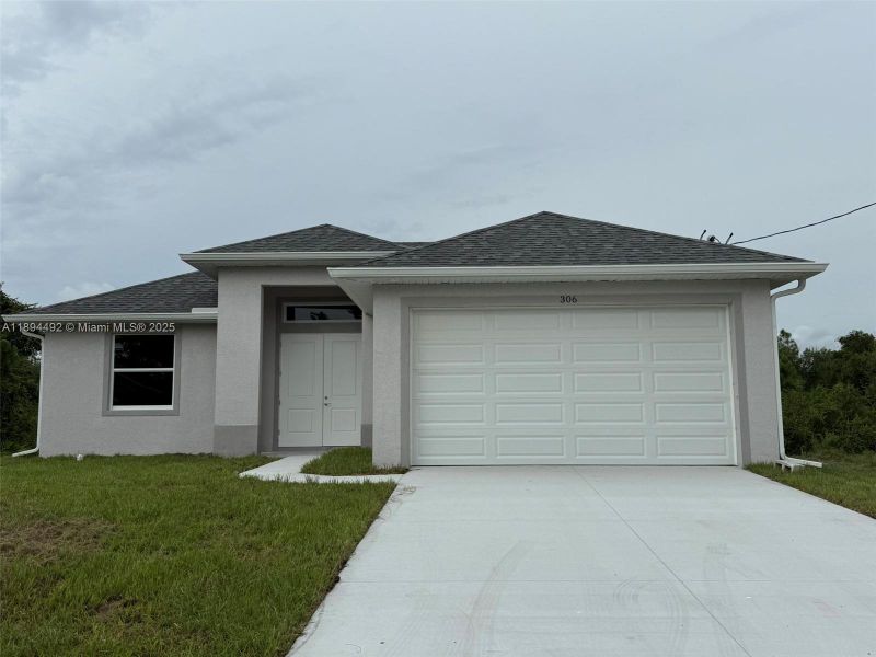 Front exterior of a new home in , Lehigh Acres, FL, highlighting curb appeal (Image 21). Front exterior of a new home in , Lehigh Acres, FL, highlighting curb appeal (Image 21).