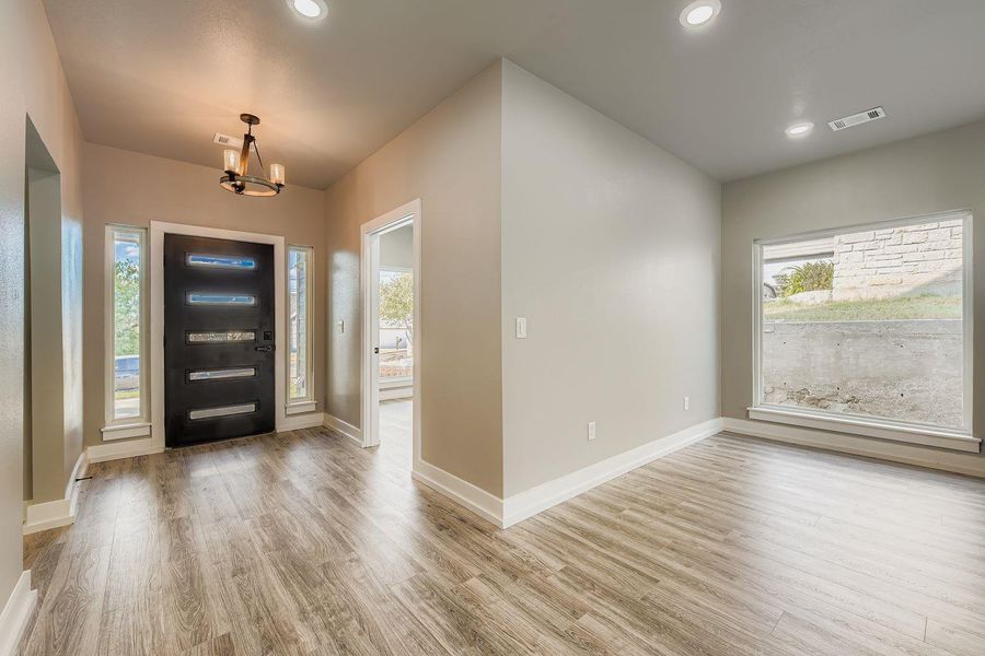 Entryway featuring light wood-style floors, a chandelier, and recessed lighting