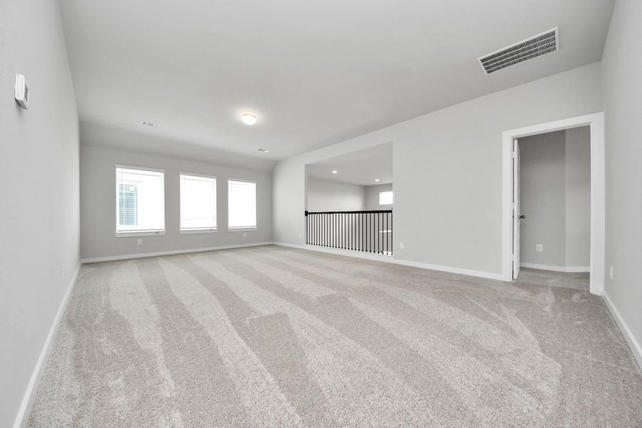Come upstairs and enjoy a day of leisure in this fabulous game room! This is the perfect hangout spot or adult game room! Features plush carpet, high ceilings, custom paint and windows for plenty of natural light.