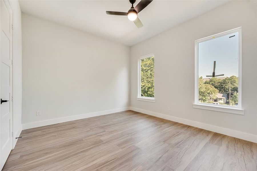 Unfurnished room with light wood-type flooring and ceiling fan Unfurnished room with light wood-type flooring and ceiling fan