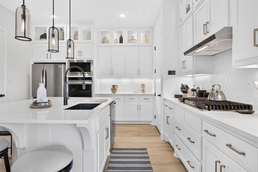 Large center island, elevated hardware, tons of storage; we love the under cabinet lighting and the gas cooktop! Large center island, elevated hardware, tons of storage; we love the under cabinet lighting and the gas cooktop!