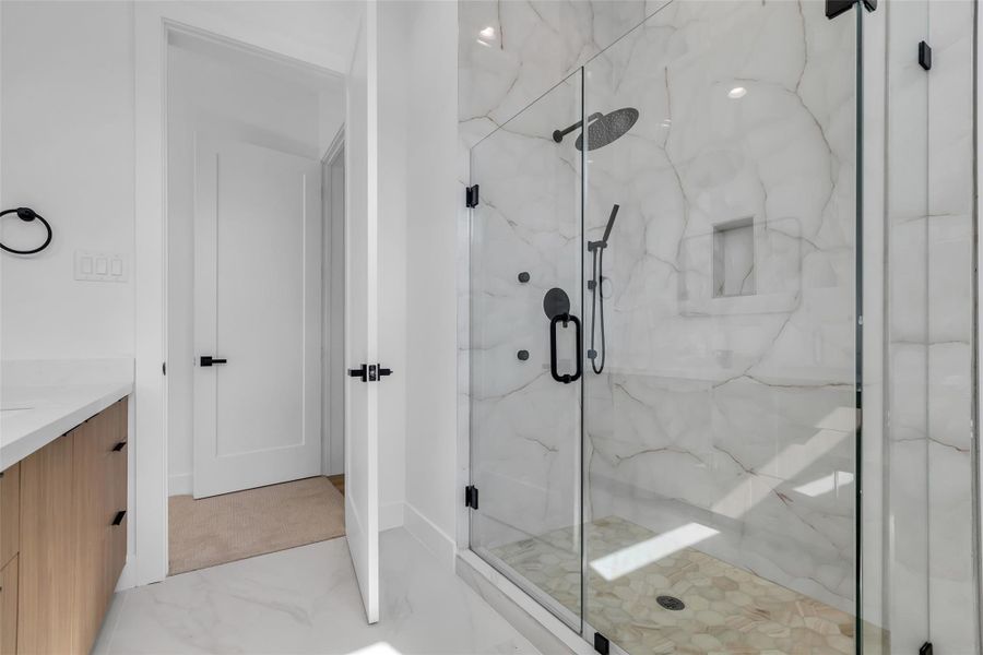 The primary bedroom includes a private bathroom with double sinks and a glass-enclosed shower, providing both convenience and comfort. The primary bedroom includes a private bathroom with double sinks and a glass-enclosed shower, providing both convenience and comfort.