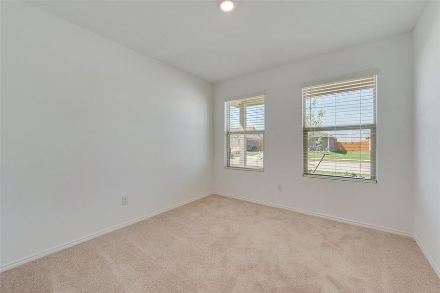 Unfurnished room featuring light colored carpet