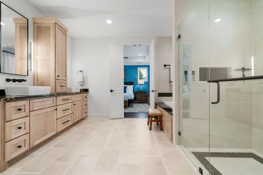 Spacious primary bathroom features plenty of storage with beautiful design and attention to details. Spacious primary bathroom features plenty of storage with beautiful design and attention to details.