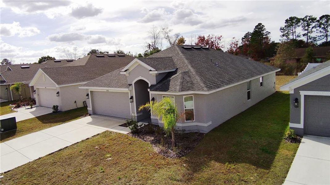 Front exterior of a new home in Pine Bluff, Spring Hill, FL, highlighting curb appeal (Image 21).