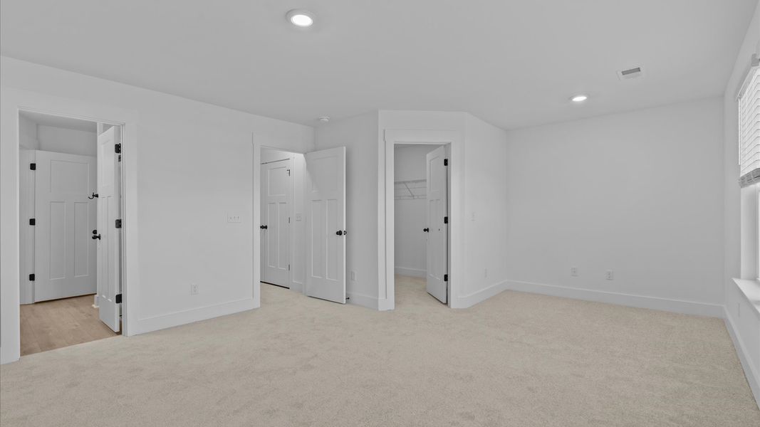 Vibrant natural light fills this exceptional primary suite with eye-catching details