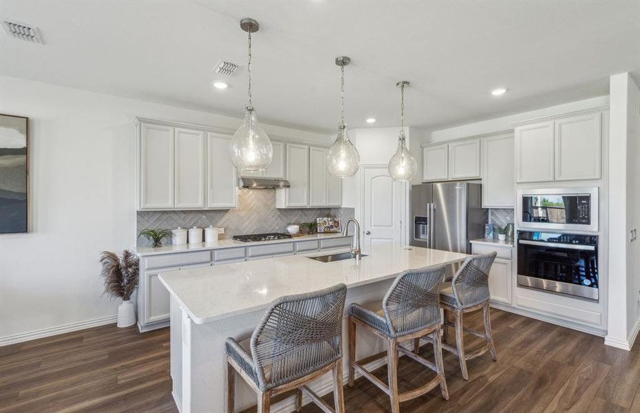 Bright kitchen with oversized island *real home pictured, model furniture not included