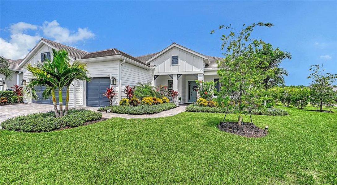 Front exterior of a new home in Windward, Lakewood Ranch, FL, highlighting curb appeal (Image 21). Front exterior of a new home in Windward, Lakewood Ranch, FL, highlighting curb appeal (Image 21).