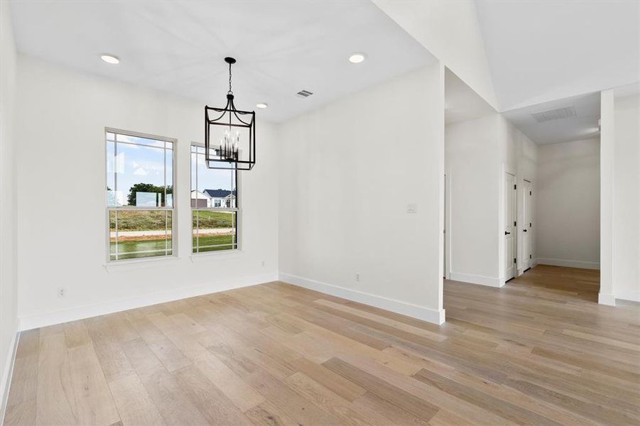 Dining Room with a chandelier, light wood-style floors, baseboards, and recessed lighting Dining Room with a chandelier, light wood-style floors, baseboards, and recessed lighting