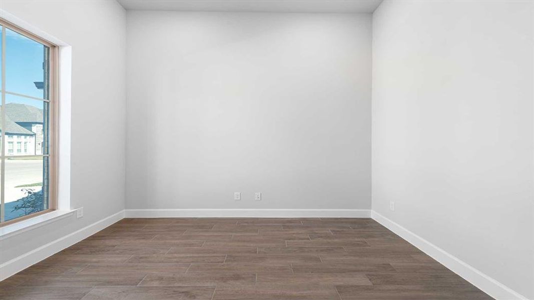 Spare room with hardwood / wood-style floors