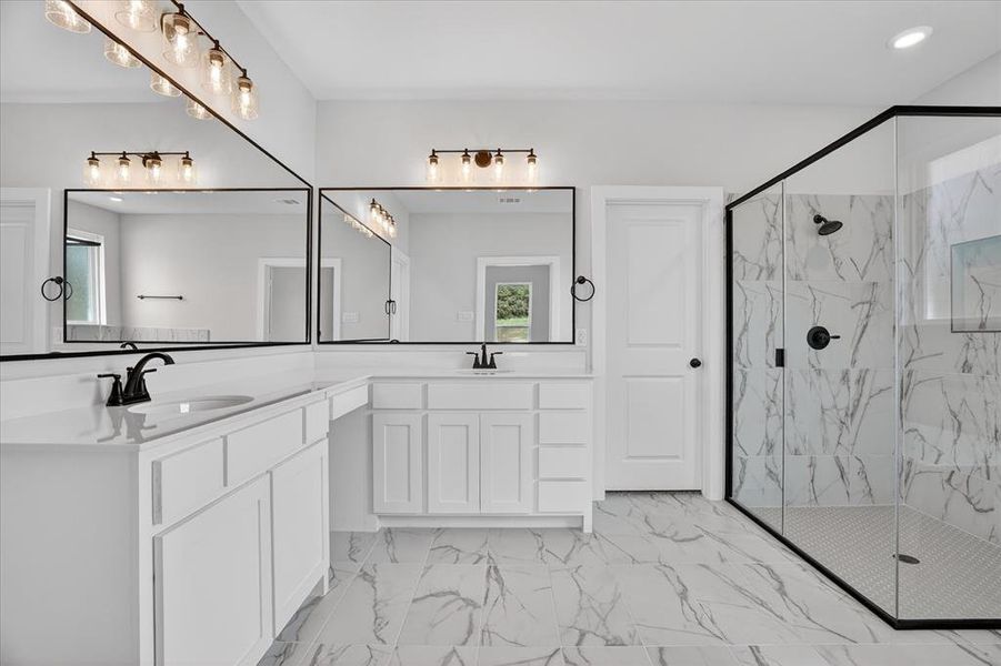 Spacious bathroom featuring a dual vanity with white cabinetry and countertops, two rectangular mirrors, and matte black fixtures