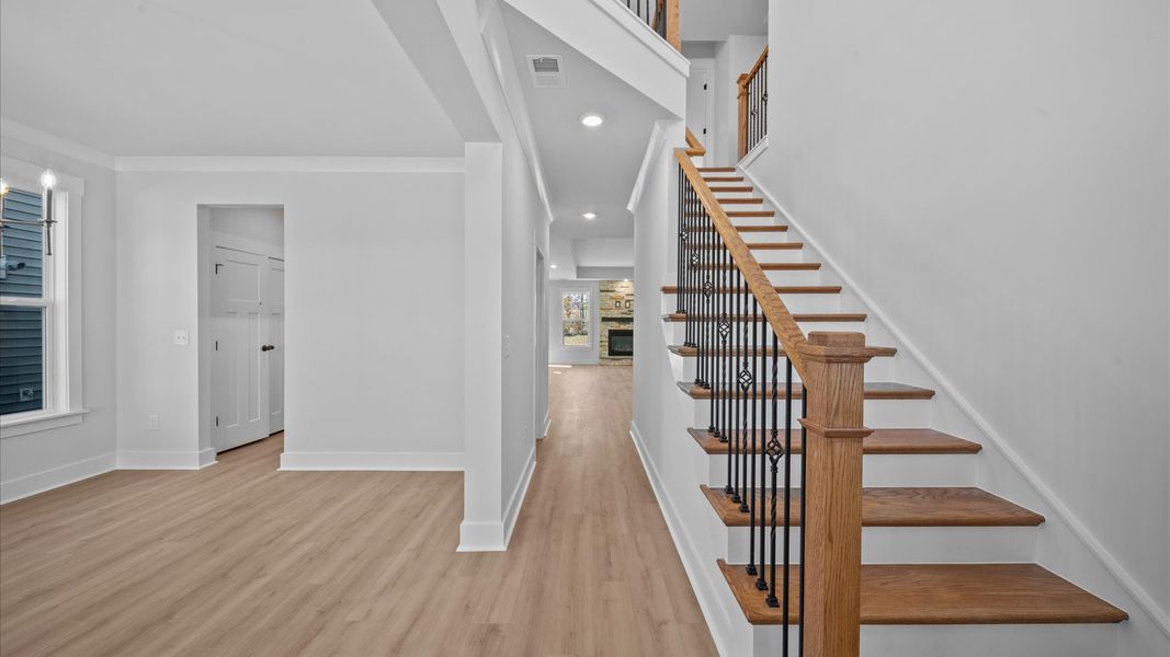 Memorable arrival experience with hardwood floors and elegant trim in the foyer