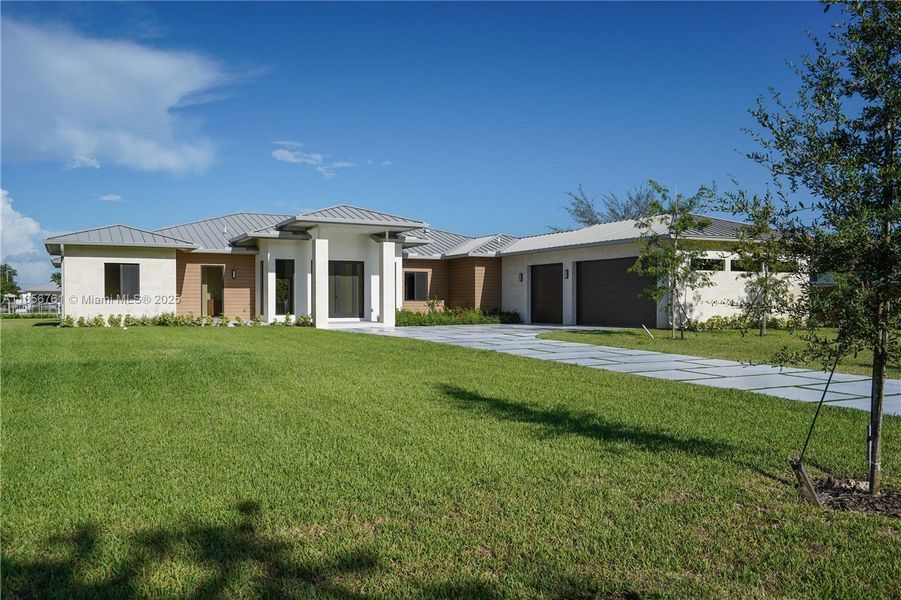 Front exterior of a new home in , Homestead, FL, highlighting curb appeal (Image 37).