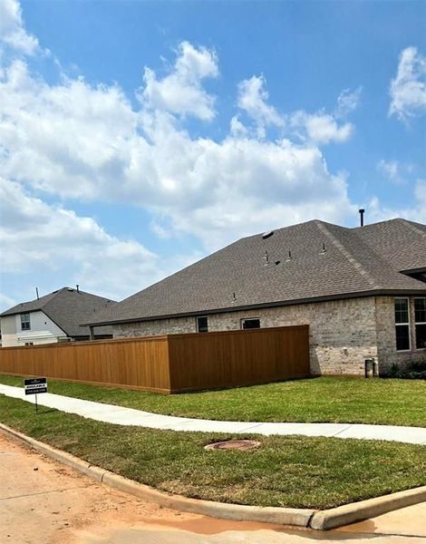 Front exterior of a new home in Sunterra, Katy, TX, highlighting curb appeal (Image 16).