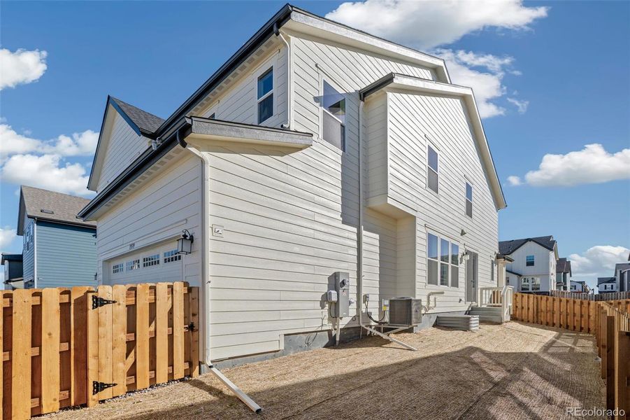 Exterior details and patio area of a home in Turnberry Villas, Commerce City (Image 24).