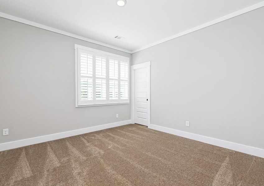 Secondary bedroom with carpet.