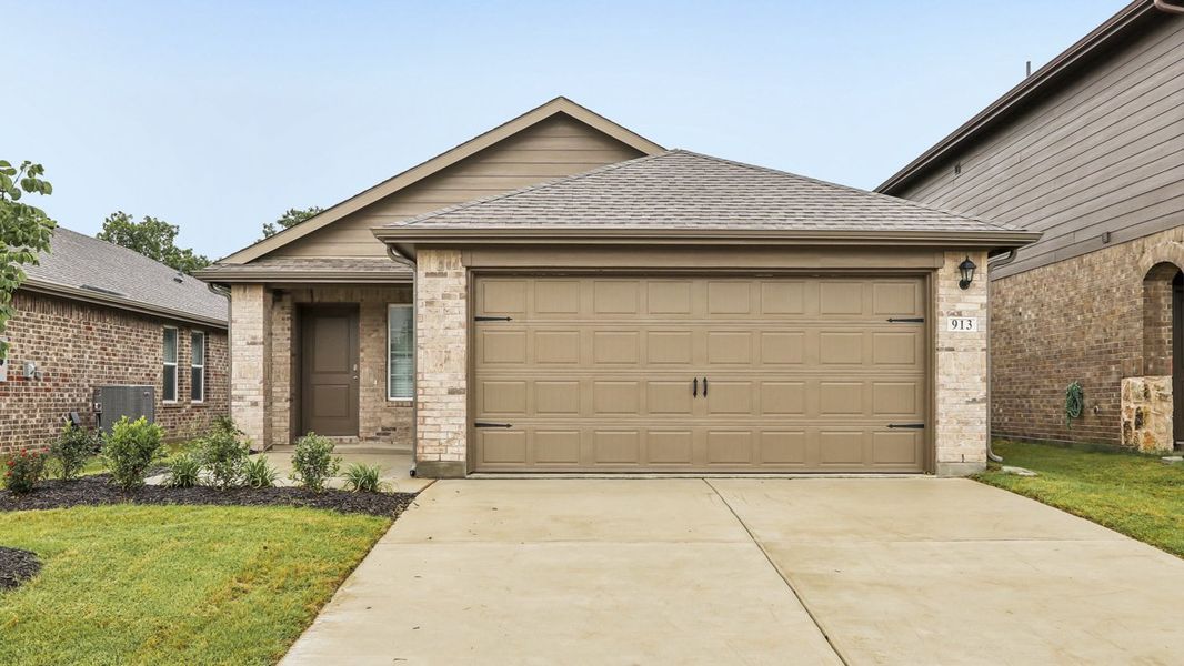 Front exterior of a new home in Hanolley Hills, Sherman, TX, highlighting curb appeal (Image 2). Front exterior of a new home in Hanolley Hills, Sherman, TX, highlighting curb appeal (Image 2).