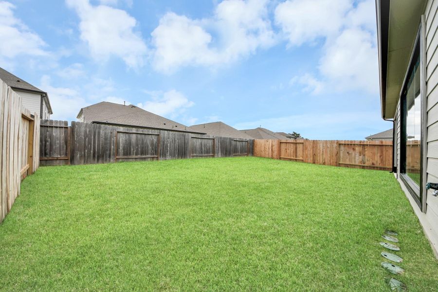 Discover the charm of this spacious backyard featuring a delightful covered patio. With ample room for both play and relaxation, it's the perfect outdoor haven. Tailor this space to your liking with patio furniture, a BBQ pit, and more. The potential for creating your dream outdoor living area is limitless! Discover the charm of this spacious backyard featuring a delightful covered patio. With ample room for both play and relaxation, it's the perfect outdoor haven. Tailor this space to your liking with patio furniture, a BBQ pit, and more. The potential for creating your dream outdoor living area is limitless!