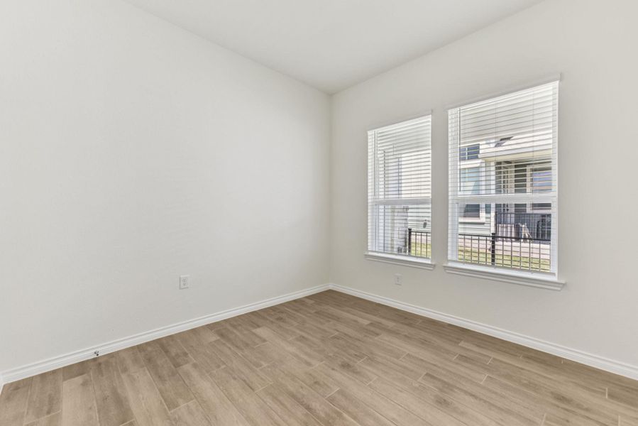 Spare room with baseboards and light wood-style flooring Spare room with baseboards and light wood-style flooring