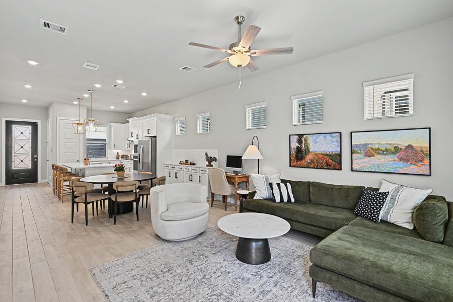 The open layout connects the family room, kitchen, and dining area, complemented by abundant windows and beautiful lighting. The open layout connects the family room, kitchen, and dining area, complemented by abundant windows and beautiful lighting.