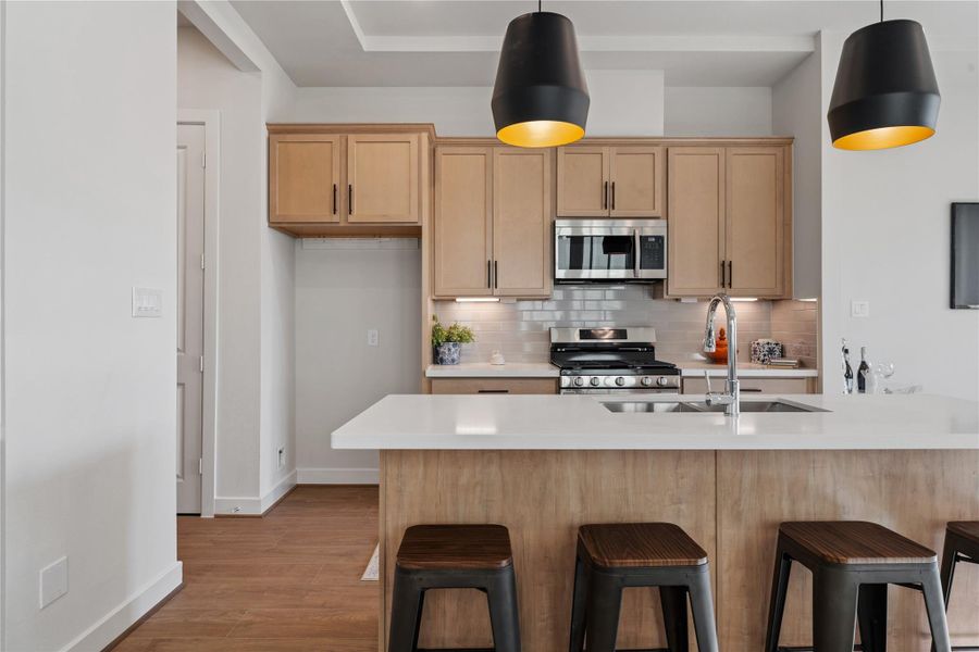 White subway tile, shaker cabinets, and stainless Samsung appliances make the kitchen a working space that actually looks good. White subway tile, shaker cabinets, and stainless Samsung appliances make the kitchen a working space that actually looks good.