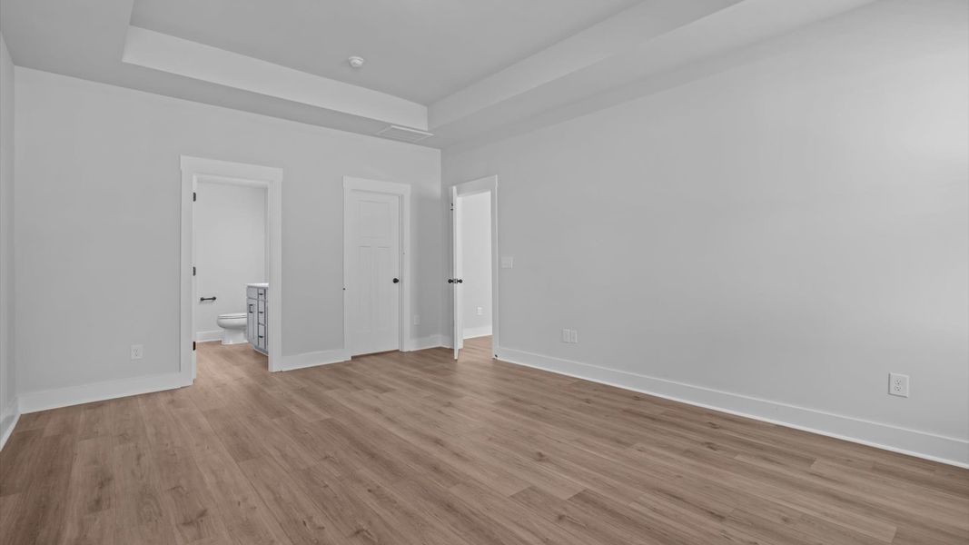 First-class hardwood floors and tasteful finishes elevate the private retreat of this exceptional primary suite