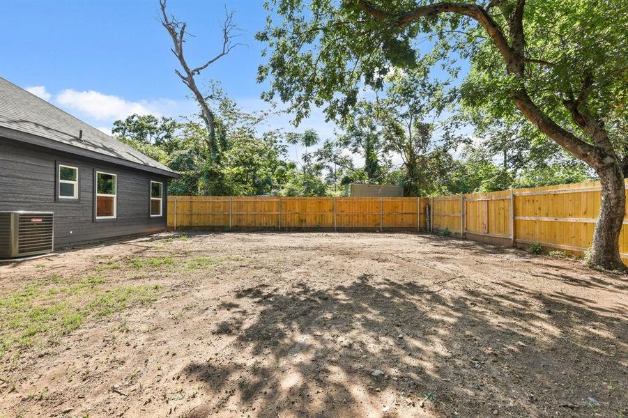 Fenced backyard with central AC unit